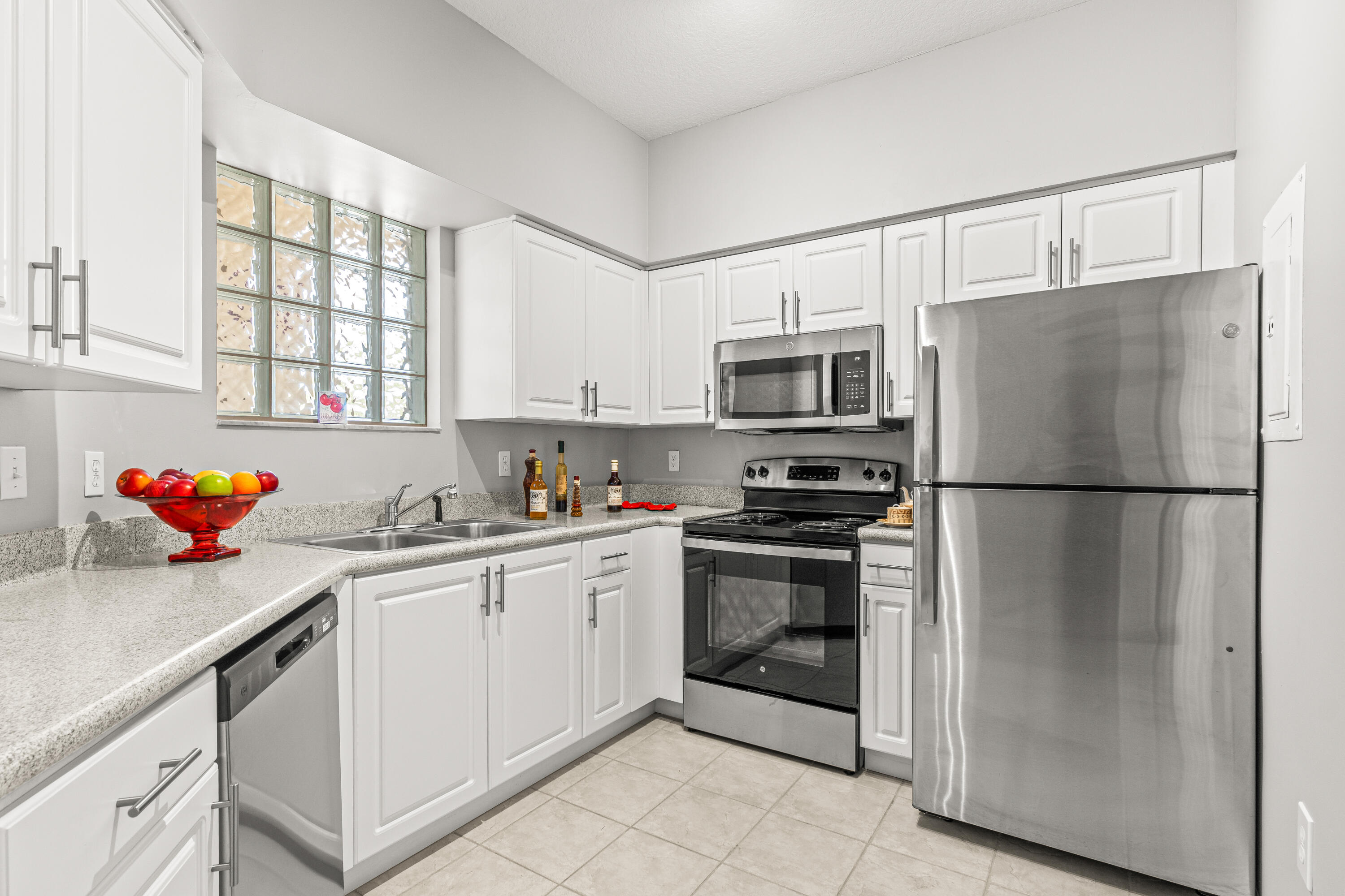 1951 Brandywine Road, Unit 207 West Palm Beach, FL 33409 - Photo 45 of 45 a kitchen with stainless steel appliances a refrigerator sink and cabinets