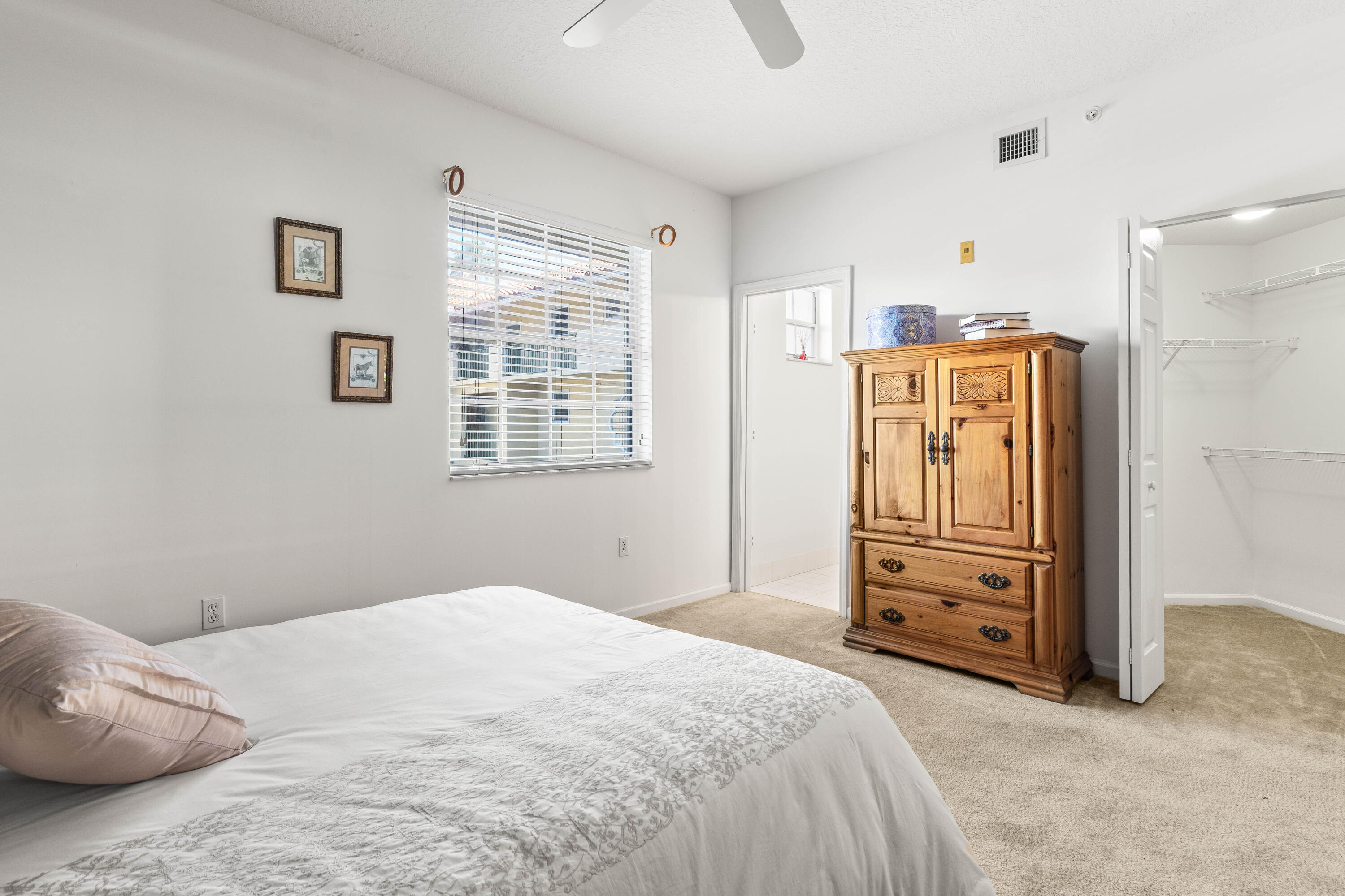 1951 Brandywine Road, Unit 207 West Palm Beach, FL 33409 - Photo 10 of 45 a bedroom with a dresser and a window