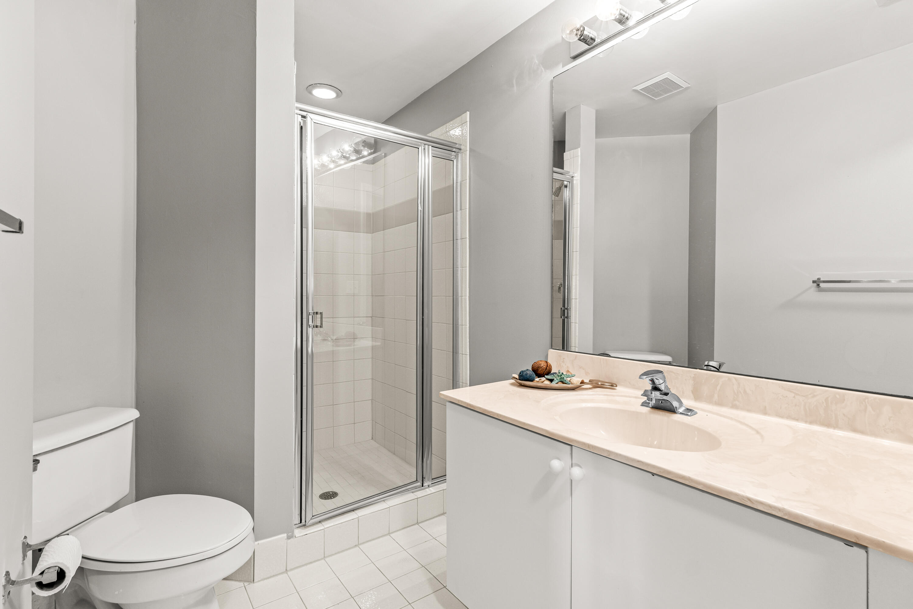 1951 Brandywine Road, Unit 207 West Palm Beach, FL 33409 - Photo 12 of 45 a bathroom with a sink toilet and shower