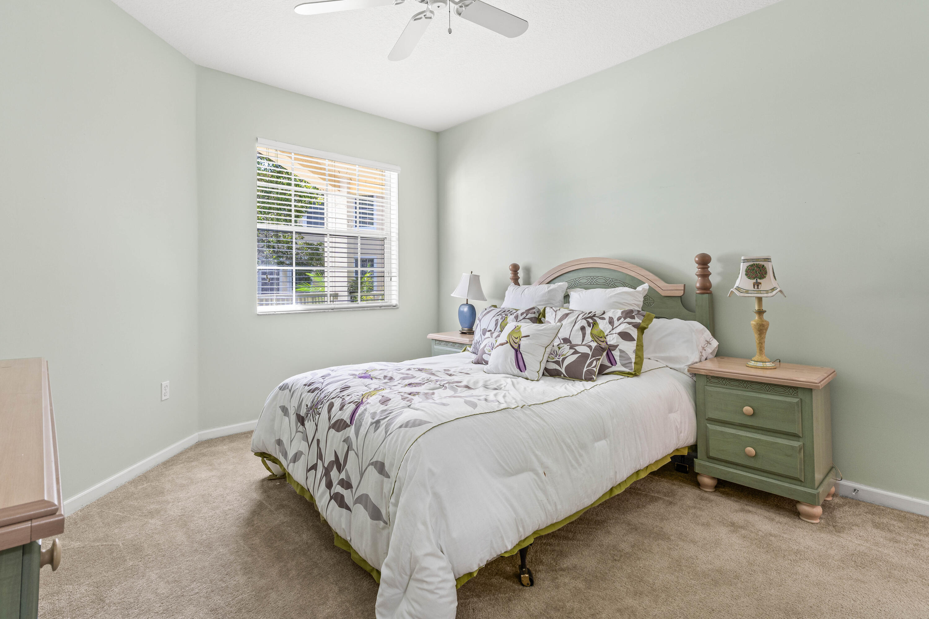 1951 Brandywine Road, Unit 207 West Palm Beach, FL 33409 - Photo 15 of 45 a bedroom with a bed and window