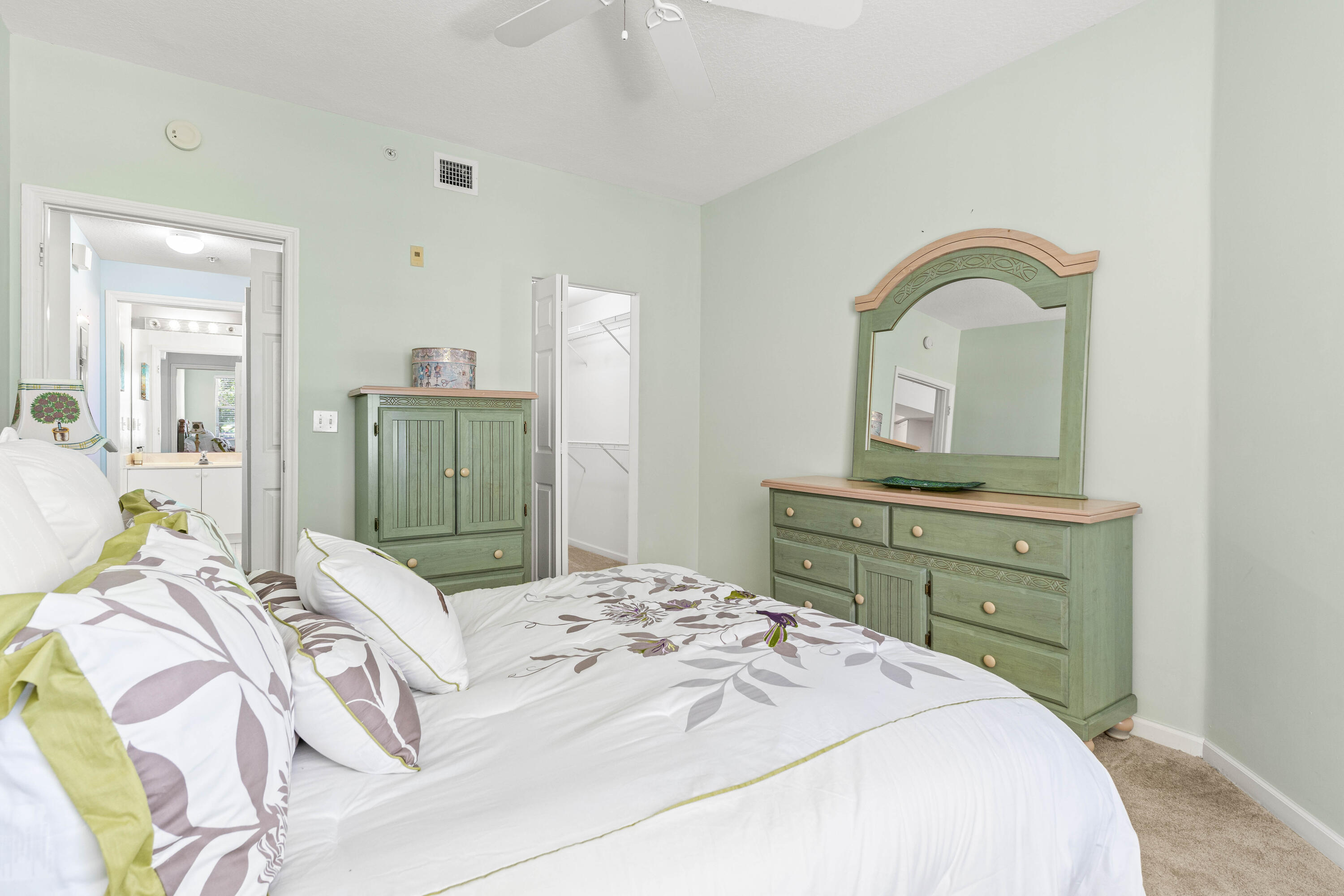 1951 Brandywine Road, Unit 207 West Palm Beach, FL 33409 - Photo 16 of 45 a bedroom with a bed and a dresser