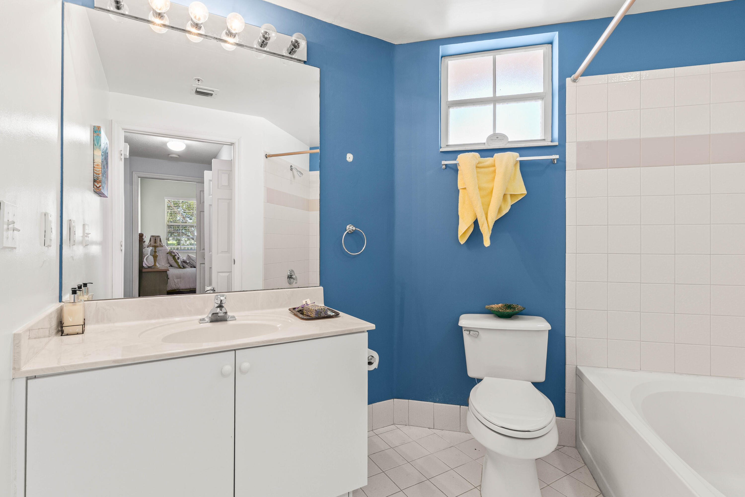1951 Brandywine Road, Unit 207 West Palm Beach, FL 33409 - Photo 19 of 45 a bathroom with a toilet sink and mirror