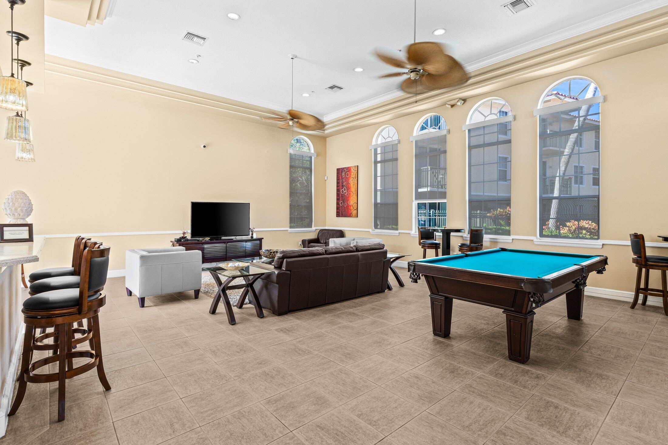 1951 Brandywine Road, Unit 207 West Palm Beach, FL 33409 - Photo 26 of 45 a living room with furniture a rug and a chandelier