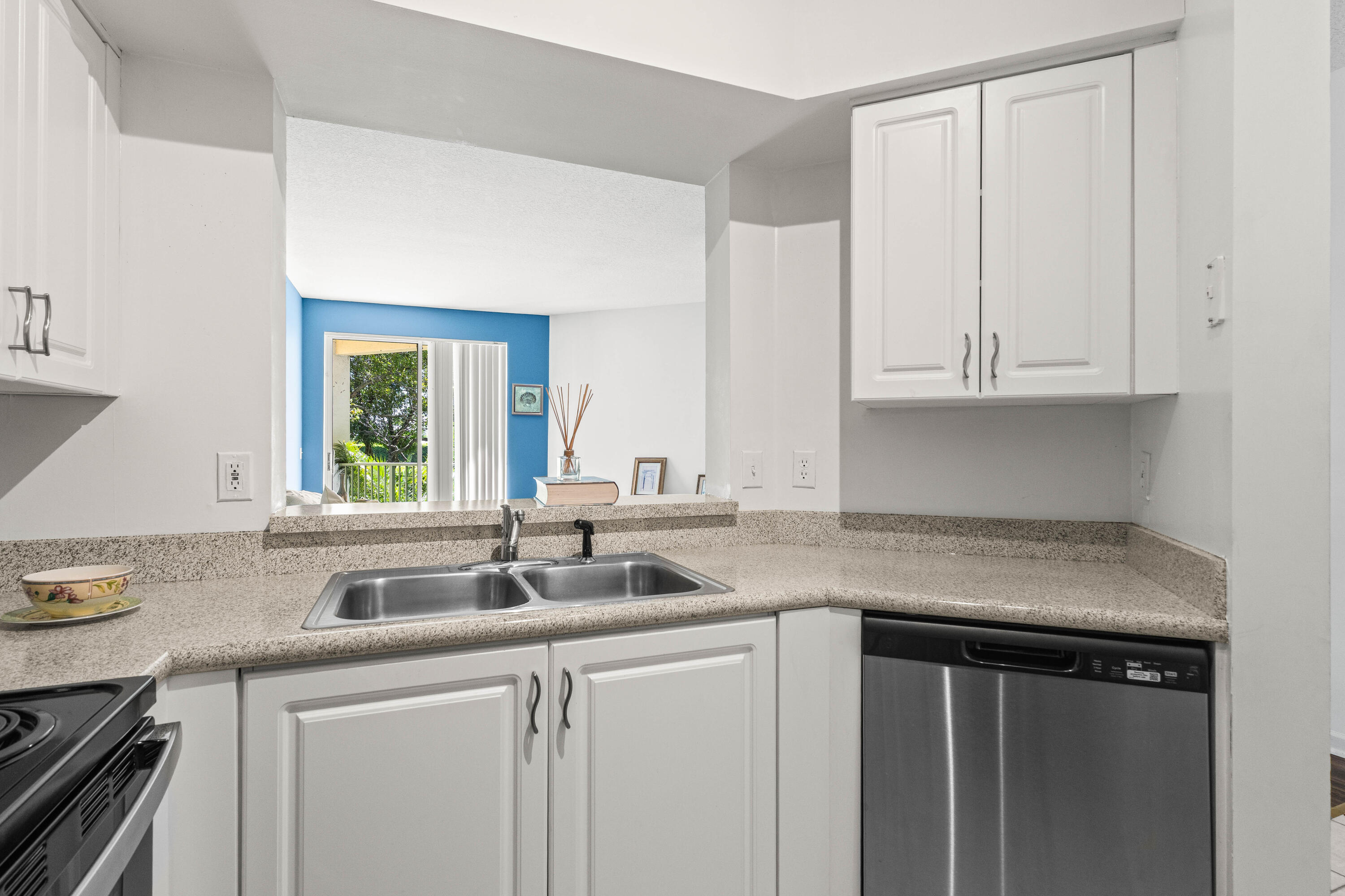 1951 Brandywine Road, Unit 207 West Palm Beach, FL 33409 - Photo 3 of 45 a kitchen with stainless steel appliances granite countertop a sink and dishwasher with white cabinets