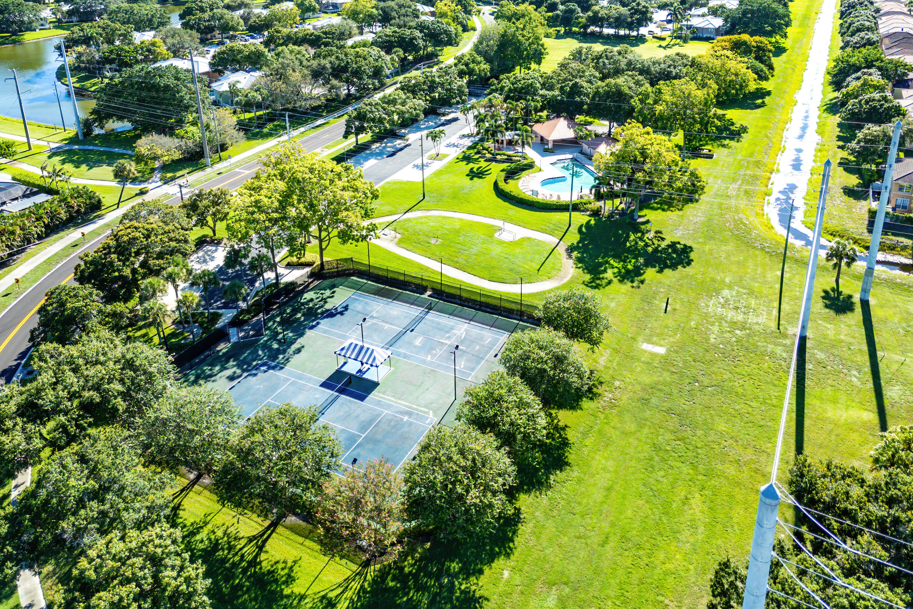 1951 Brandywine Road, Unit 207 West Palm Beach, FL 33409 - Photo 41 of 45 a view of a swimming pool with a yard