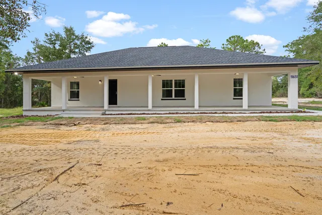 a house with swimming pool in front of it