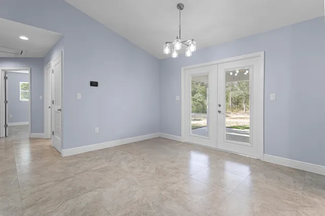 an empty room with fan and entrance