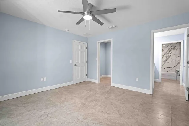 a bathroom with a granite countertop sink a vanity and window