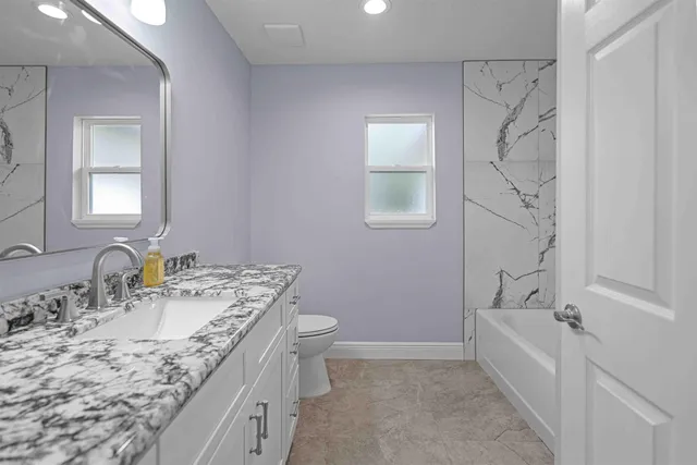 a bathroom with a bathtub and shower