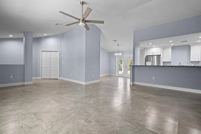 a view of a kitchen with granite countertop stainless steel appliances sink and wooden floor