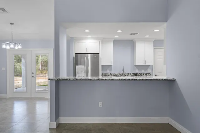 a kitchen with granite countertop cabinets stainless steel appliances and a counter space
