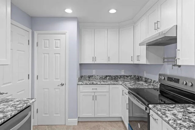 a kitchen with a refrigerator and a sink