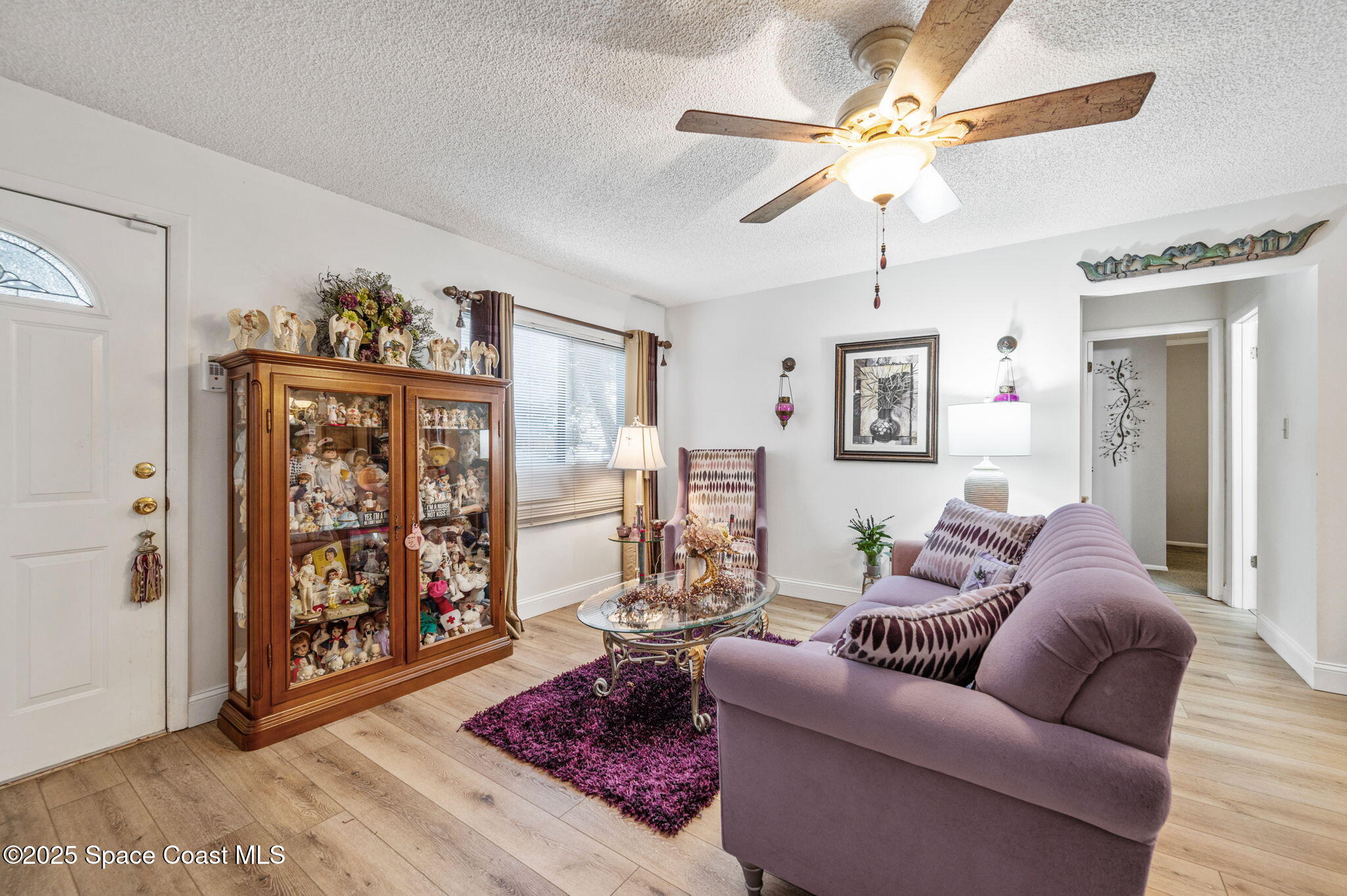 5220 Holden Road Cocoa, FL 32927 - Photo 11 of 31 a living room with furniture and a painting on the wall