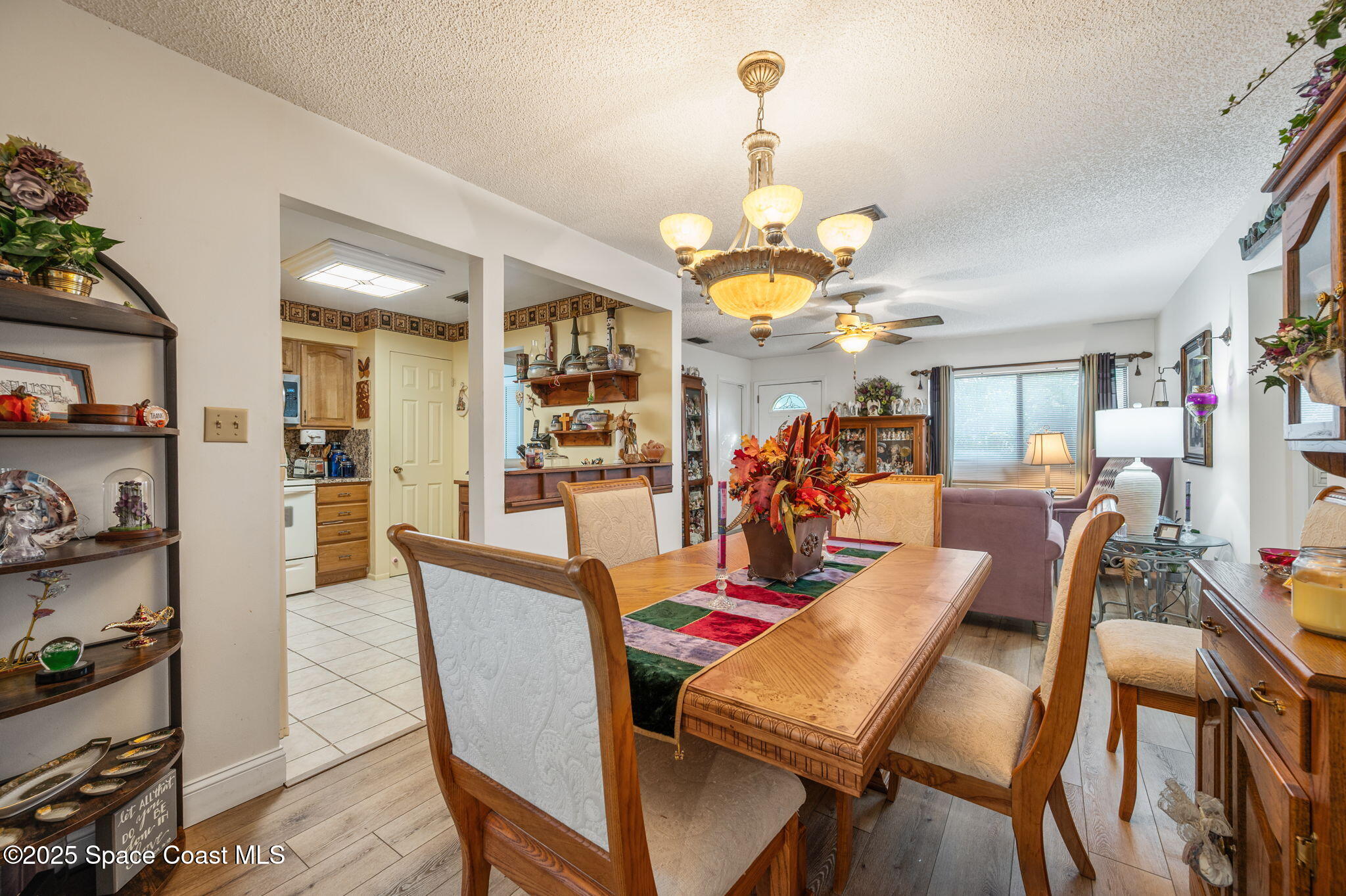 5220 Holden Road Cocoa, FL 32927 - Photo 16 of 31 a view of a dining room and livingroom with furniture wooden floor a chandelier
