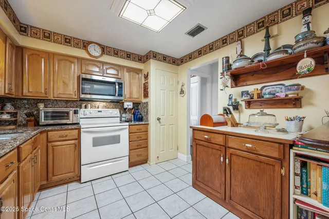 a kitchen with stainless steel appliances a stove sink and cabinets