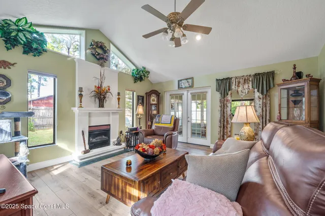 a living room with furniture a fireplace and a flat screen tv