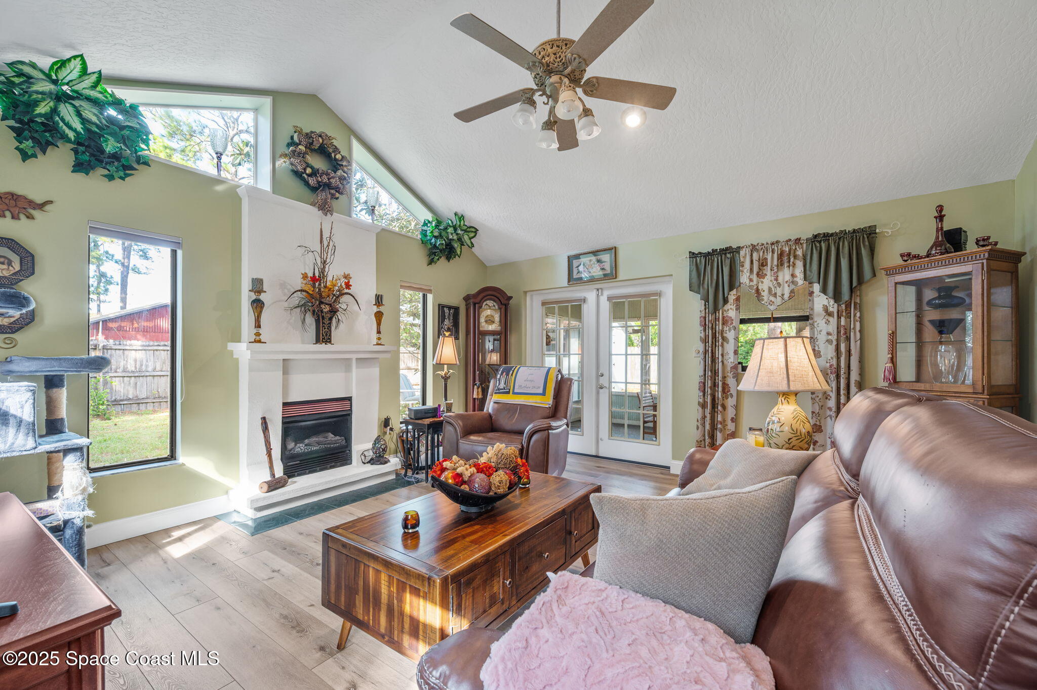 5220 Holden Road Cocoa, FL 32927 - Photo 21 of 31 a living room with furniture a fireplace and a flat screen tv