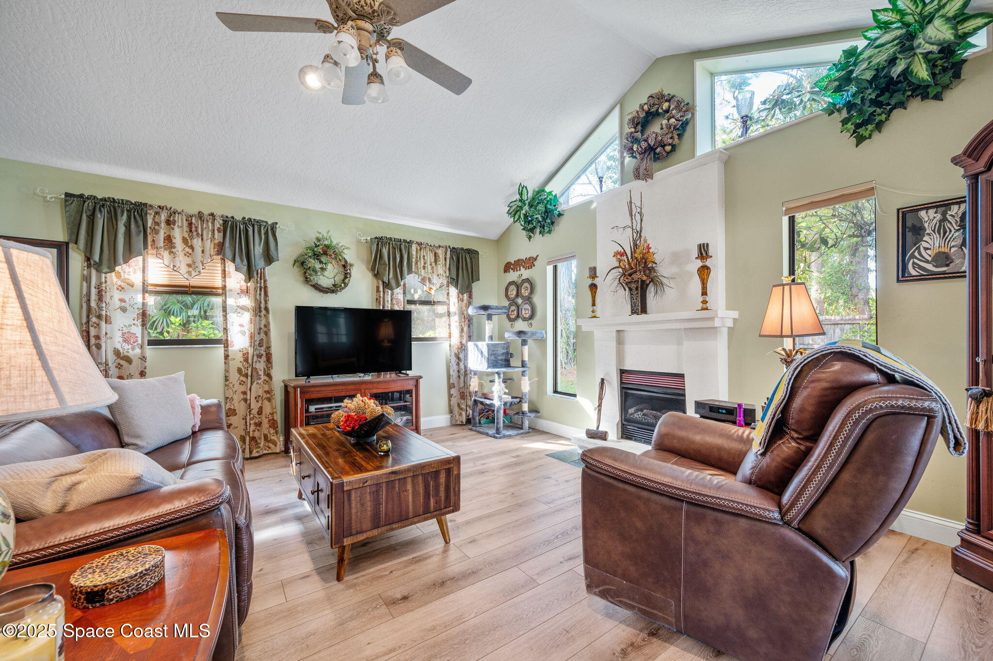 5220 Holden Road Cocoa, FL 32927 - Photo 23 of 31 a living room with fireplace furniture and a flat screen tv