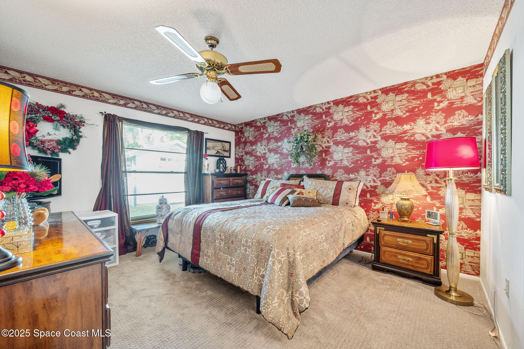 5220 Holden Road Cocoa, FL 32927 - Photo 24 of 31 a bedroom with a bed and a chandelier