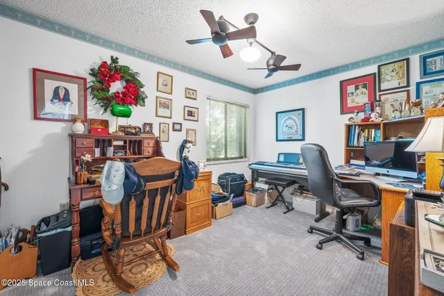a view of a workspace with furniture and a workspace