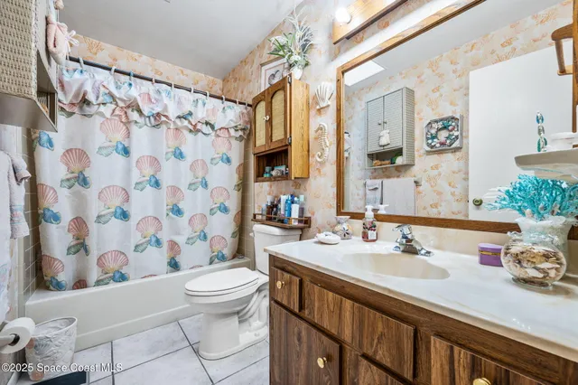 a bathroom with a sink a toilet and shower curtain