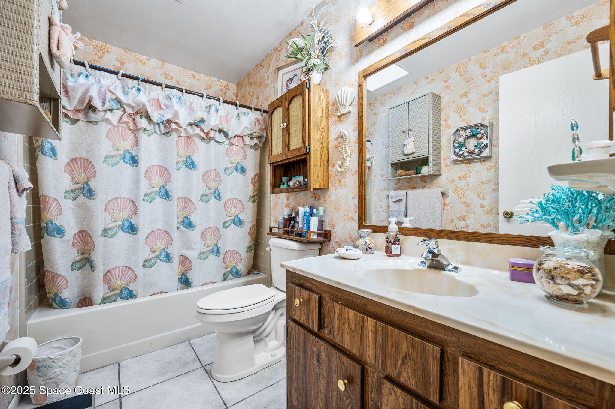 5220 Holden Road Cocoa, FL 32927 - Photo 29 of 31 a bathroom with a sink a toilet and shower curtain