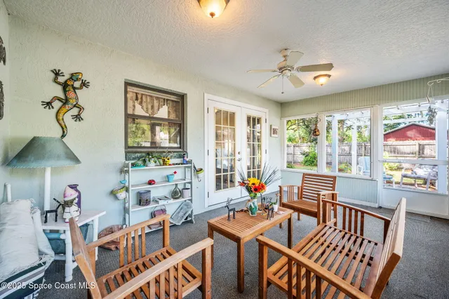 a bedroom with furniture a window and a chandelier