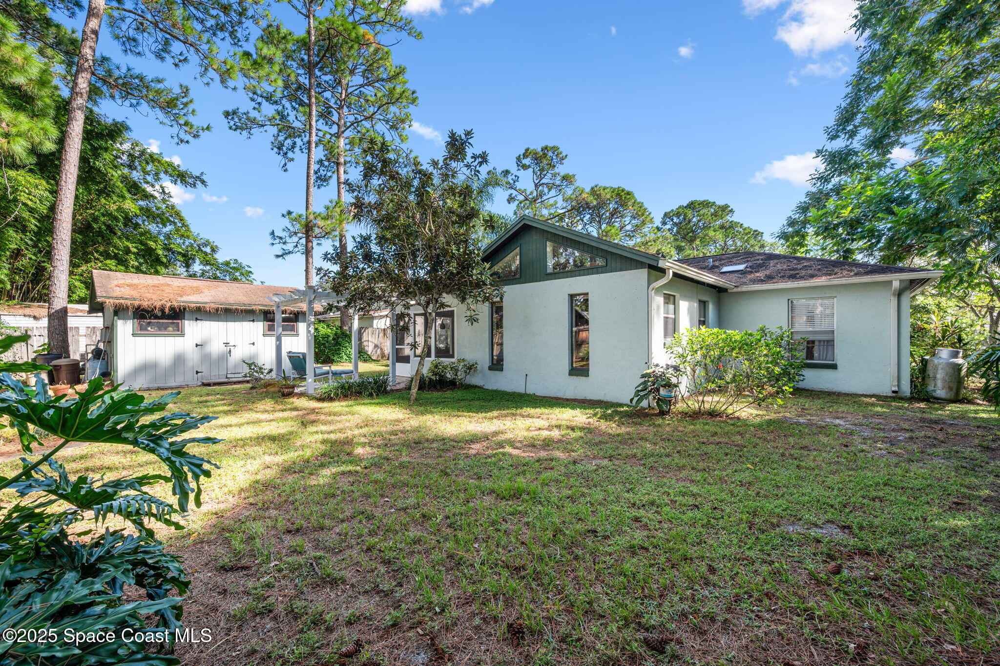 5220 Holden Road Cocoa, FL 32927 - Photo 7 of 31 a yellow house with trees in the background