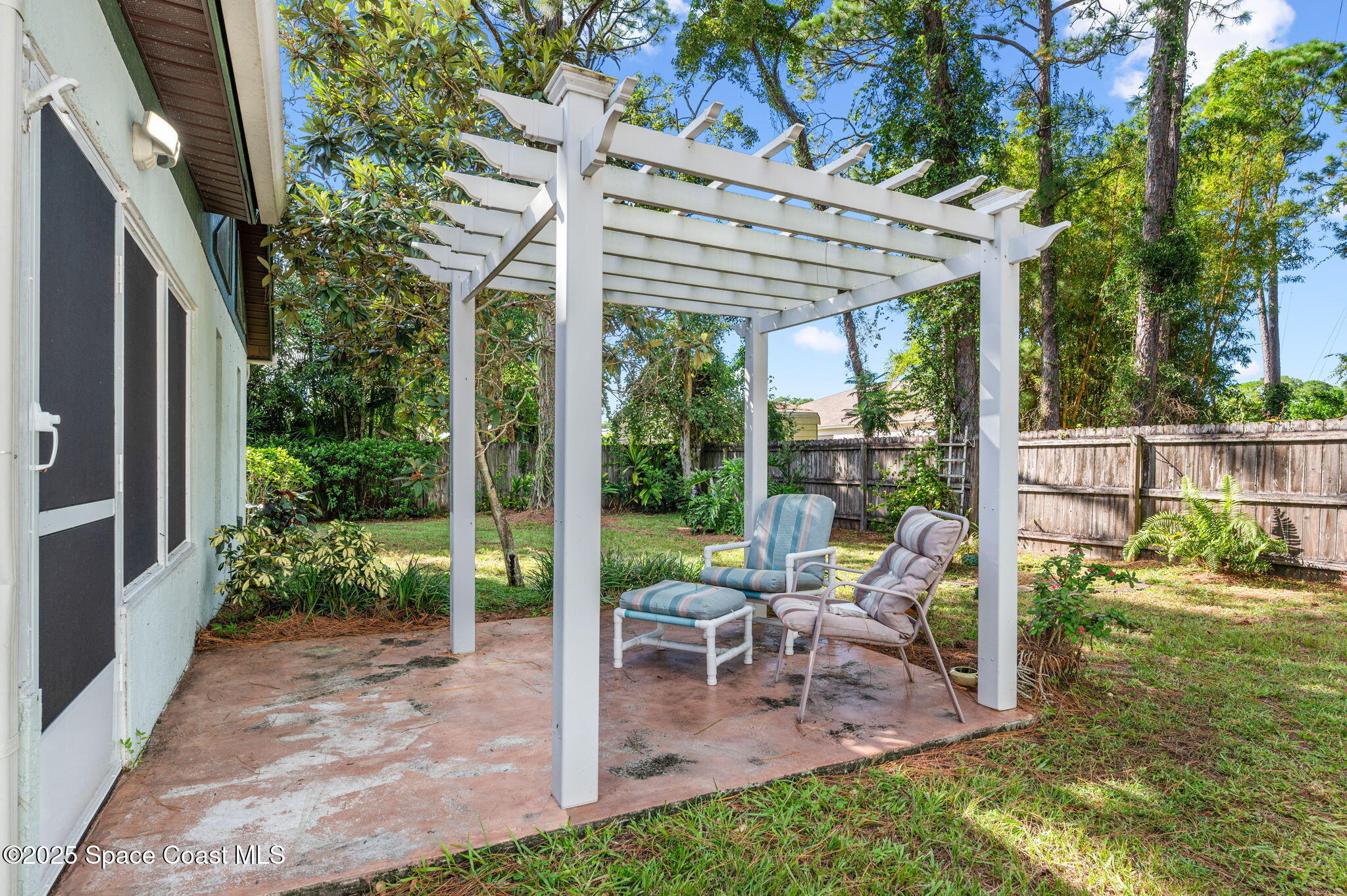 5220 Holden Road Cocoa, FL 32927 - Photo 9 of 31 a view of a patio with a table chairs and a backyard