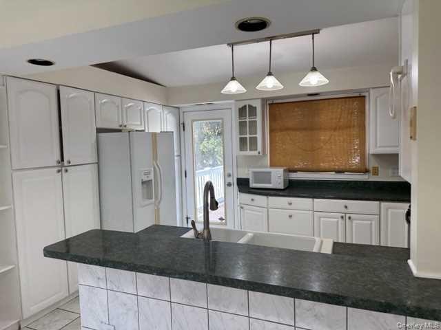 131 Spackenkill Road Poughkeepsie, NY 12603 - Photo 2 of 14 a kitchen with stainless steel appliances granite countertop a sink a stove and a refrigerator