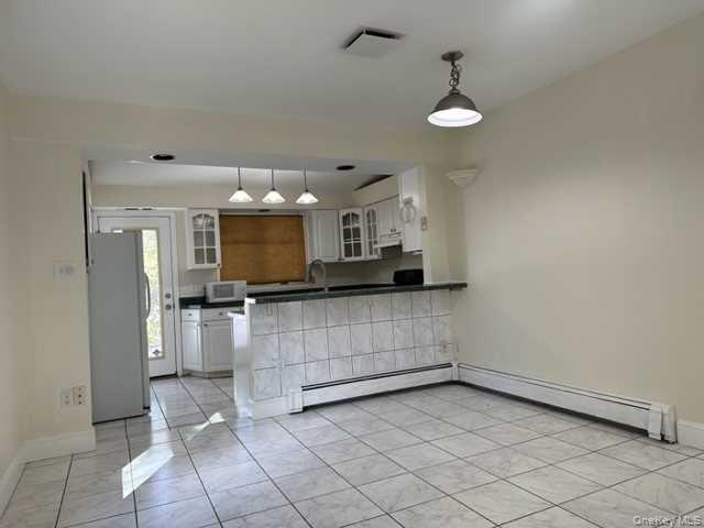 131 Spackenkill Road Poughkeepsie, NY 12603 - Photo 4 of 14 a view of kitchen with refrigerator and window