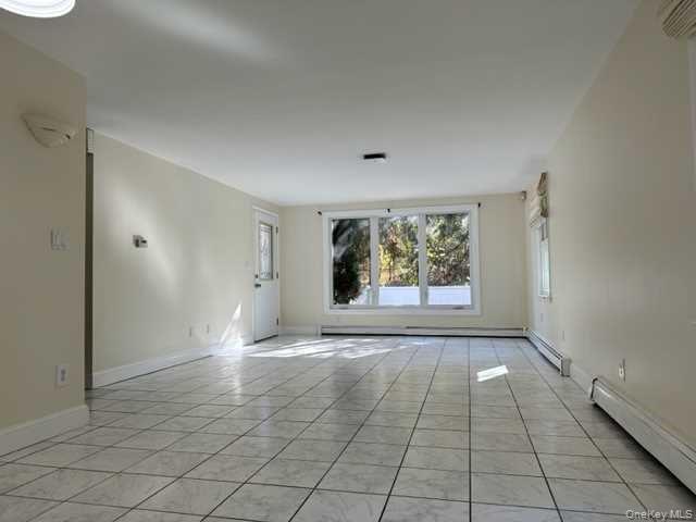 131 Spackenkill Road Poughkeepsie, NY 12603 - Photo 5 of 14 an empty room with windows and entrance