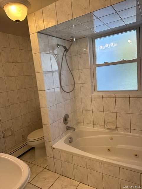 131 Spackenkill Road Poughkeepsie, NY 12603 - Photo 9 of 14 a bathroom with a tub a toilet and a sink
