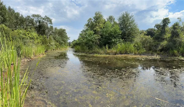 a view of a lake view with houses in back