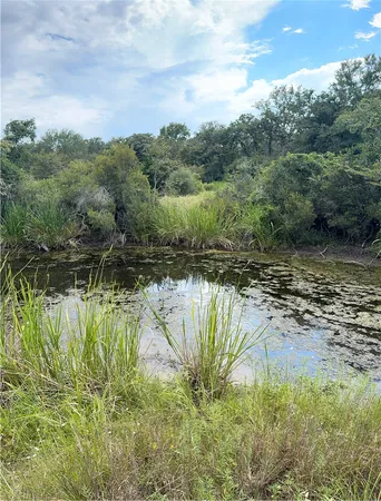 a view of a lake view with houses in background