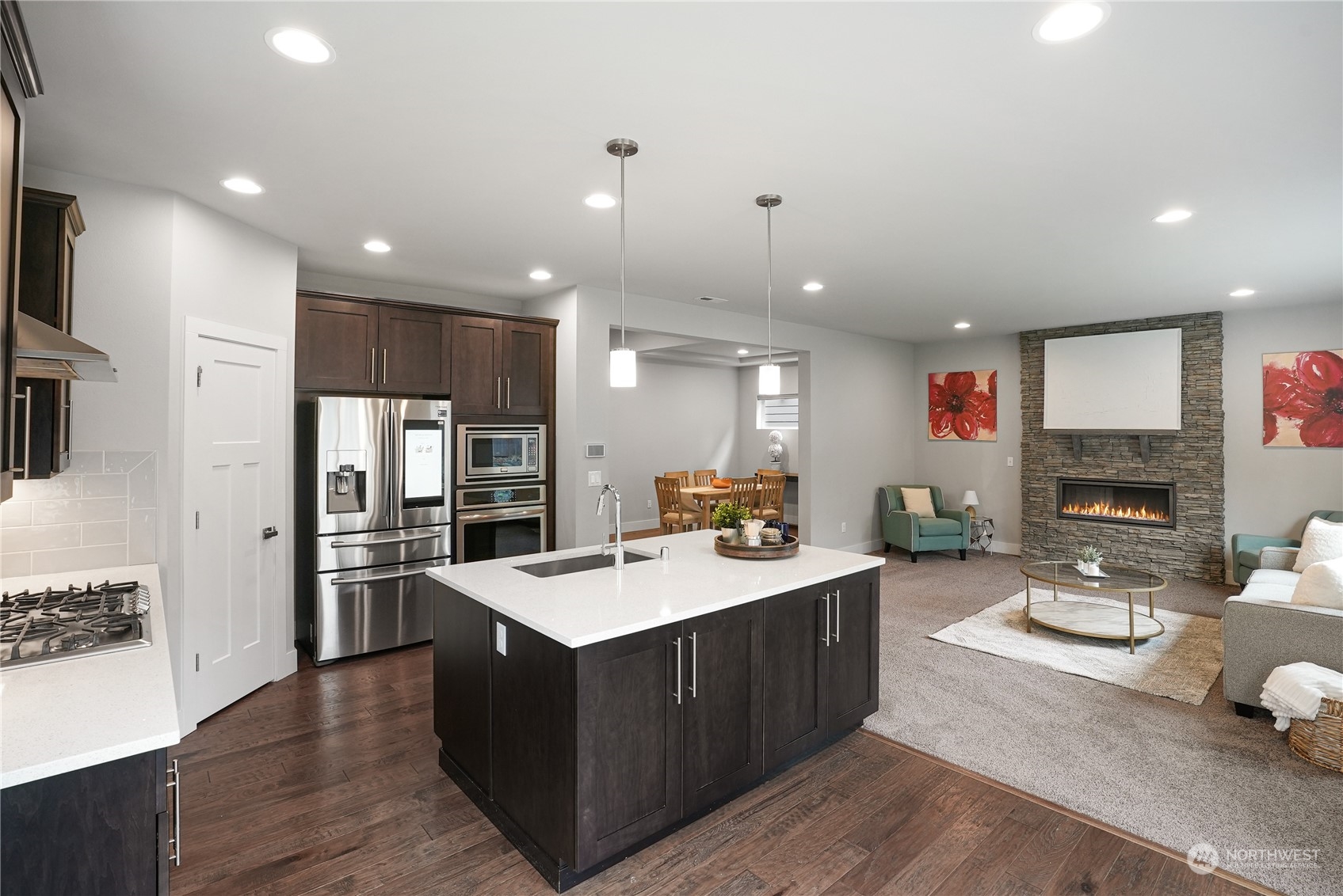 1218 198th Place Southeast Bothell, WA 98012 - Photo 12 of 38 a large kitchen with stainless steel appliances kitchen island a large counter top and a refrigerator