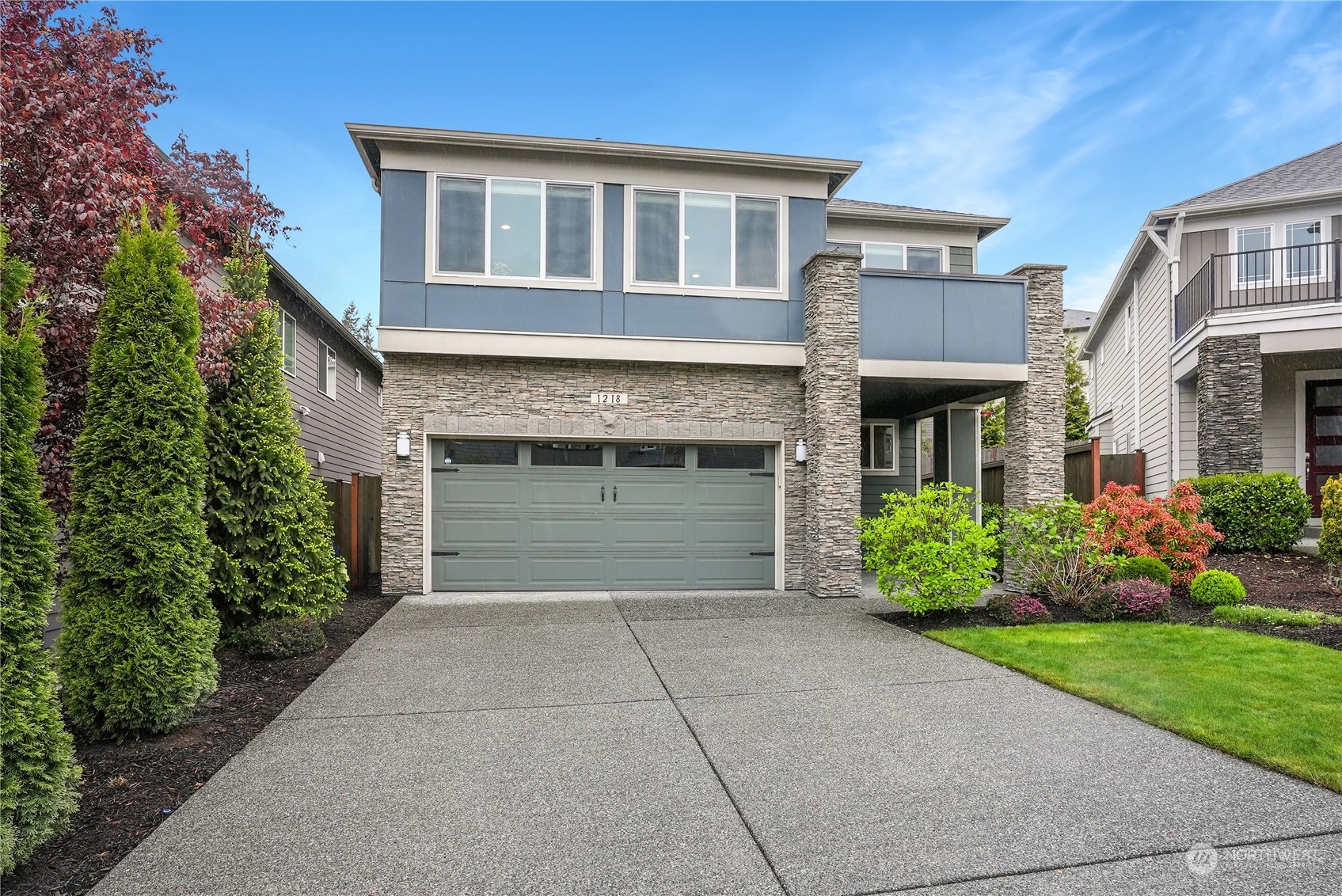 1218 198th Place Southeast Bothell, WA 98012 - Photo 2 of 38 a front view of a house with garden