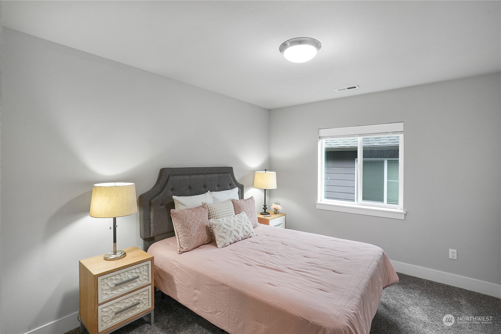 1218 198th Place Southeast Bothell, WA 98012 - Photo 24 of 38 a bedroom with a bed and a lamp