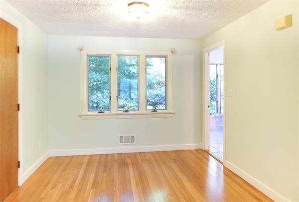10 Highgate Road Wayland, MA 01778 - Photo 3 of 29 a view of an empty room with wooden floor and a window