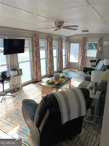 a large bedroom with a bed and wooden floor