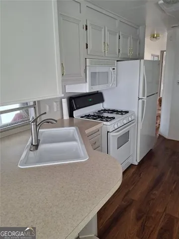 a view of a patio with table and chairs and wooden floor