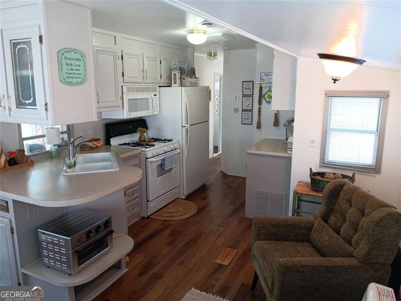 4 Fleetwood Road, Unit 502 Cleveland, GA 30528 - Photo 24 of 45 a living room with stainless steel appliances furniture a fireplace and a kitchen view