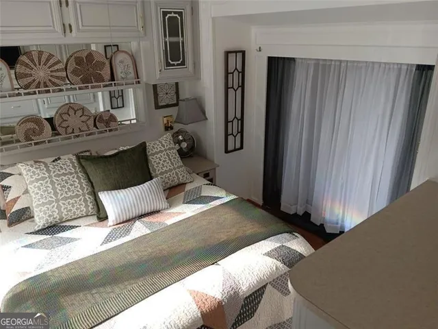 a bedroom with a bed and a mirror