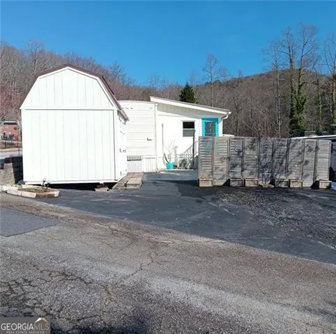a view of a house with a backyard