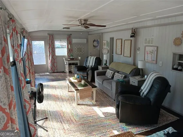 a living room with fireplace furniture and a rug