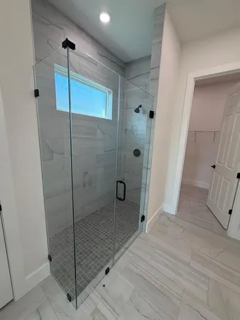 a bathroom with a shower and a sink
