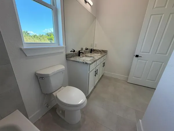 a white toilet sitting next to a bathroom sink
