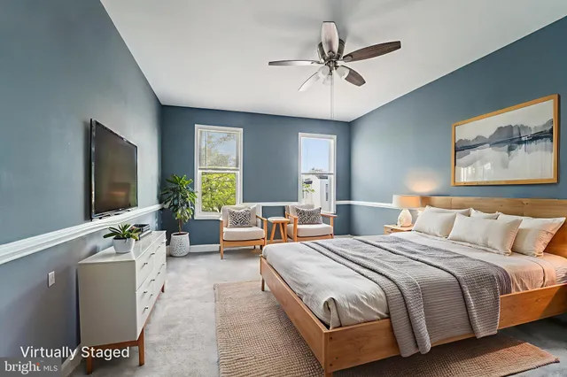 a spacious bedroom with a large bed and a chandelier