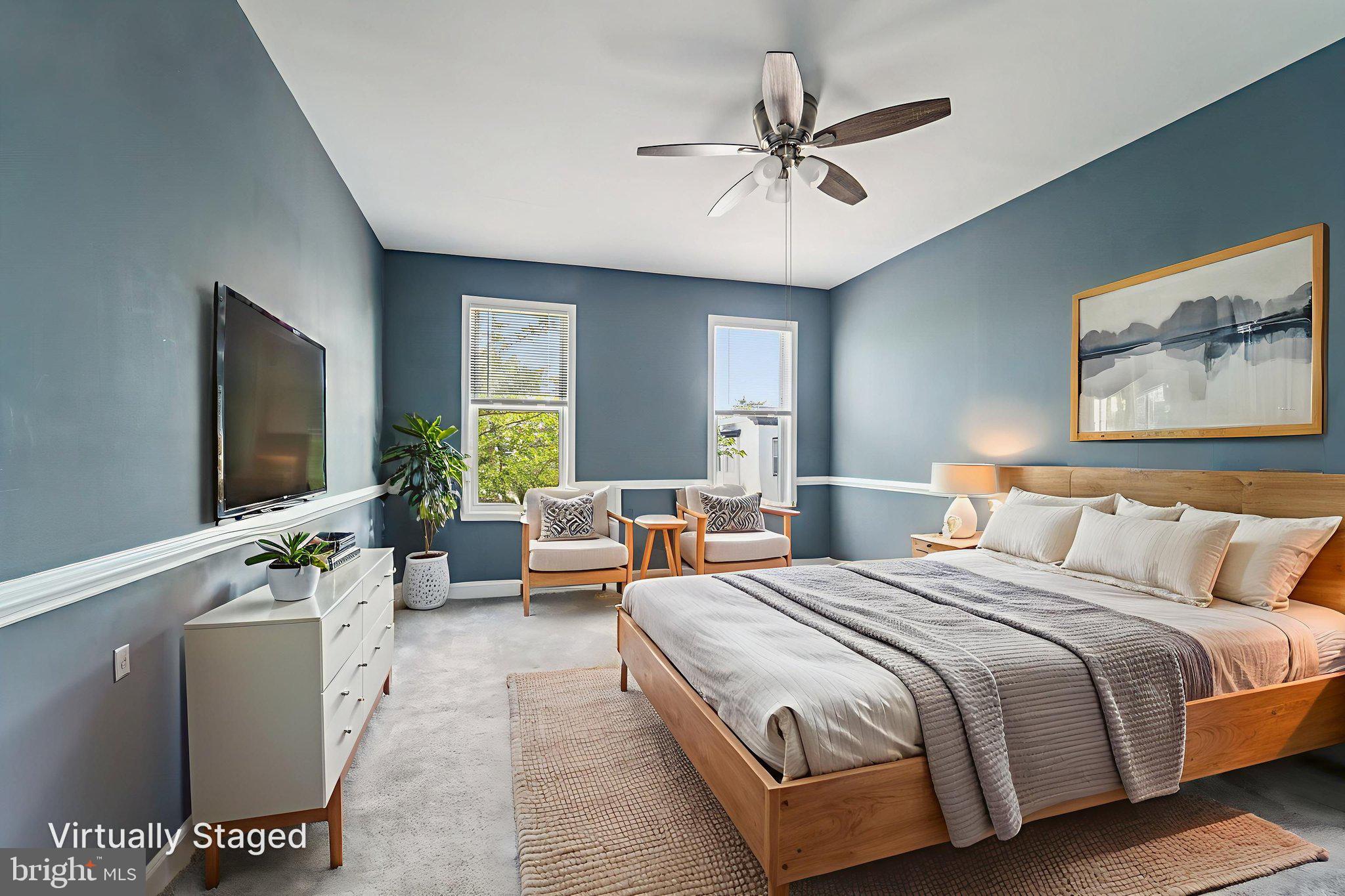 1820 East Lafayette Avenue Baltimore, MD 21213 - Photo 11 of 17 a spacious bedroom with a large bed and a chandelier