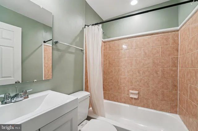 a bathroom with a sink mirror toilet and bathtub